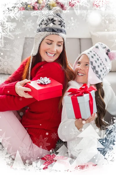 Mother and daughter exchanging gifts at christmas — Stock Photo, Image