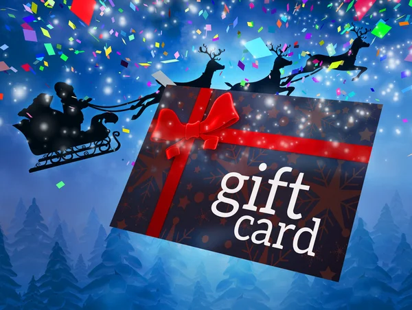 Santa flying behind gift card — Stock Photo, Image