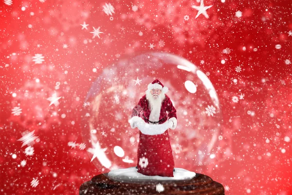 Santa hålla öppen säck i snowjordklot — Stockfoto