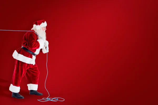 Weihnachtsmann zieht Seil — Stockfoto