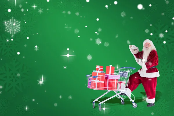 Papai Noel empurra carrinho de compras — Fotografia de Stock