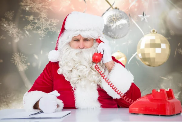Composite image of santa on the phone Royalty Free Stock Images