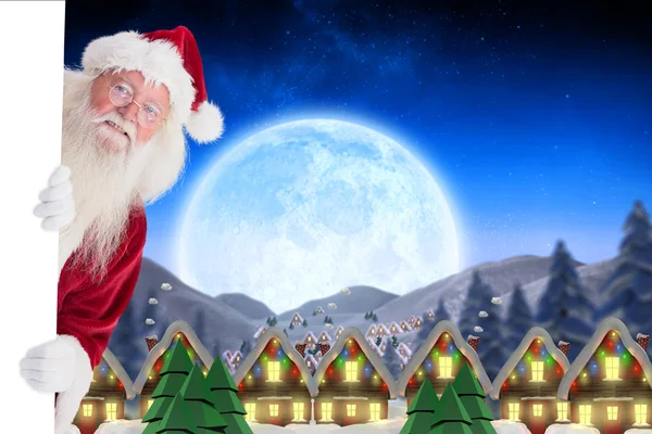 Santa looks out behind a wall — Stock Photo, Image