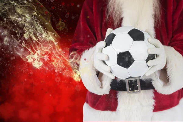 Santa hält einen klassischen Fußball — Stockfoto