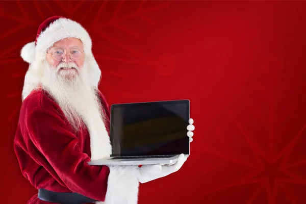 Noel Baba bir dizüstü bilgisayar sunar — Stok fotoğraf