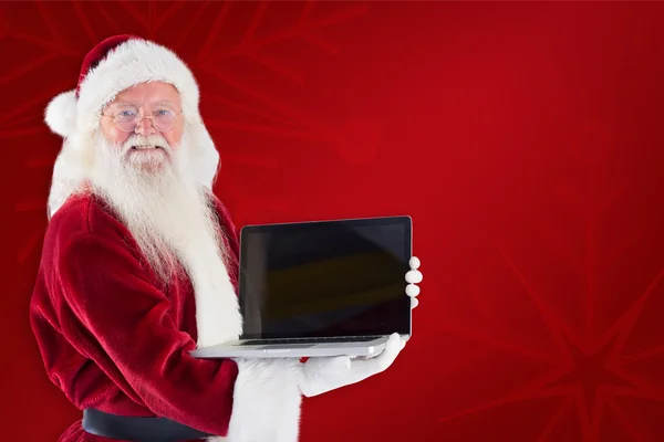 Santa Claus präsentiert einen Laptop — Stockfoto