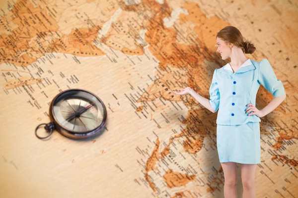 Pretty air hostess presenting with hand — Stock Photo, Image