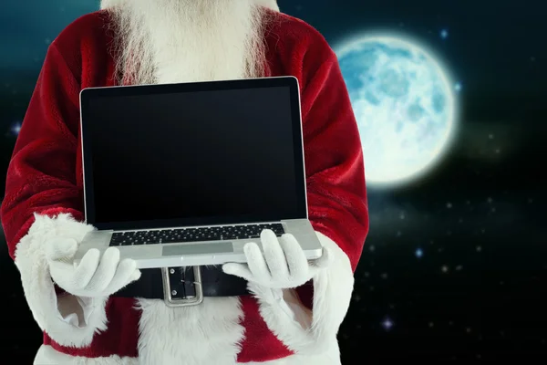 Santa Claus prezentuje laptopa — Zdjęcie stockowe