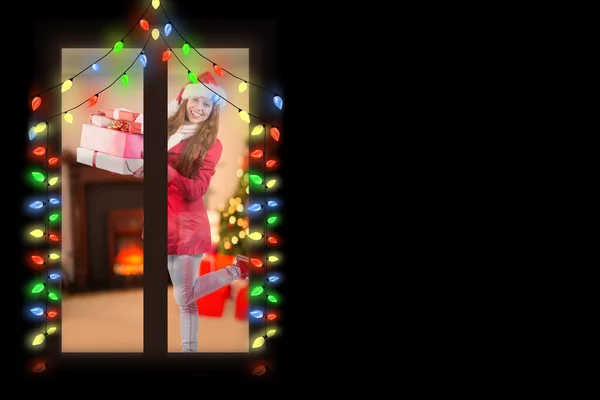 Festive redhead holding pile of gifts — Stock Photo, Image