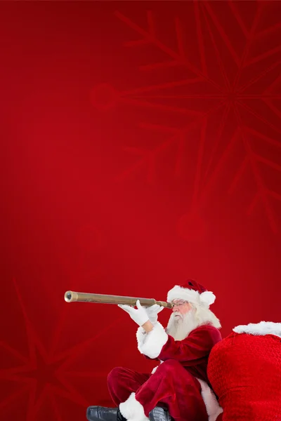 Santa claus looking through telescope — Stock Photo, Image