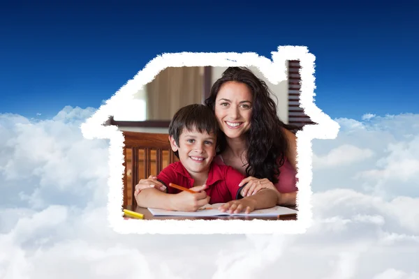 Feliz madre ayudando a su hijo para la tarea — Foto de Stock