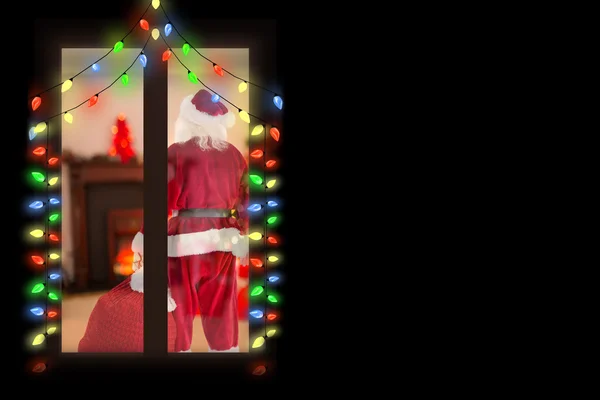 Santa carrying sack of gifts — Stock Photo, Image