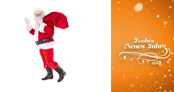 Santa holding a sack and waving — Stock Photo, Image