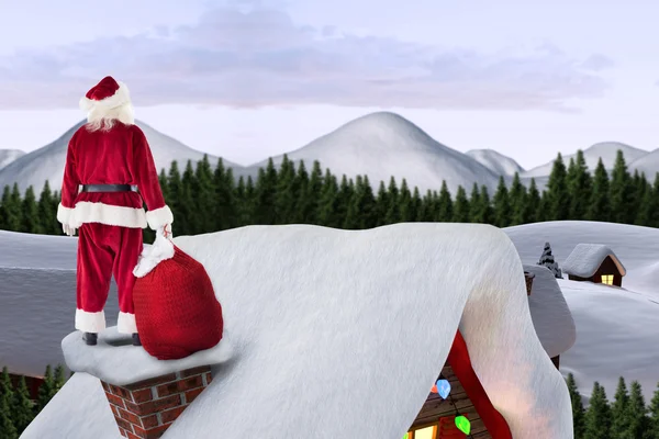 Santa on cottage roof — Stock Photo, Image