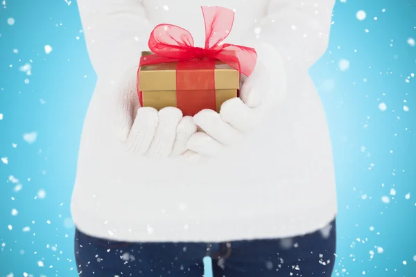 Woman in white gloves holding gift — Stock Photo, Image