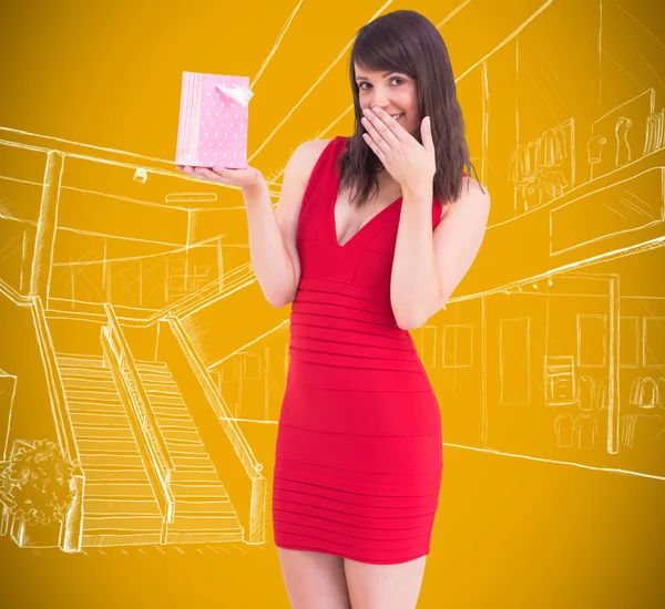 Festive brunette holding gift bag — Stock Photo, Image