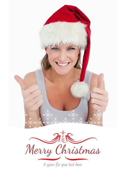 Woman with thumbs up and Christmas hat — Stock Photo, Image