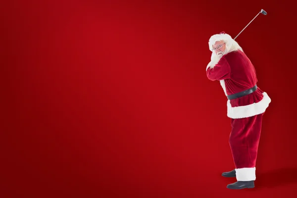 Santa Claus swings his golf club — Stock Photo, Image