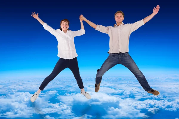 Couple jumping and holding hands — Stock Photo, Image