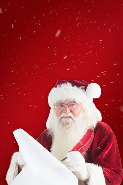 Santa Claus escribiendo en pergamino — Foto de Stock