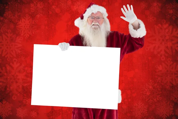 Babbo Natale tiene un segno e sta salutando — Foto Stock