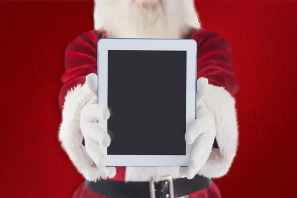 Weihnachtsmann präsentiert einen Tablet-PC — Stockfoto