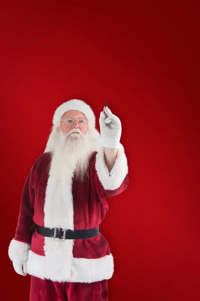 Santa schrijft iets met pen — Stockfoto