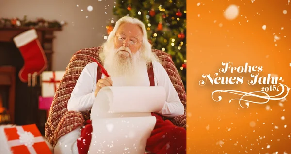 Relaxed santa writing list with a quill — Stock Photo, Image