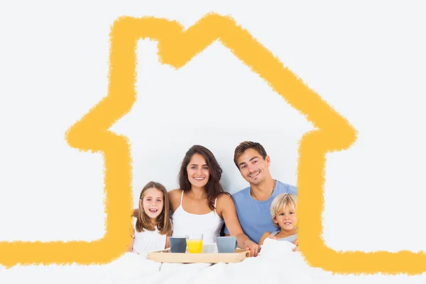 Family taking the breakfast on the bed — Stock Photo, Image