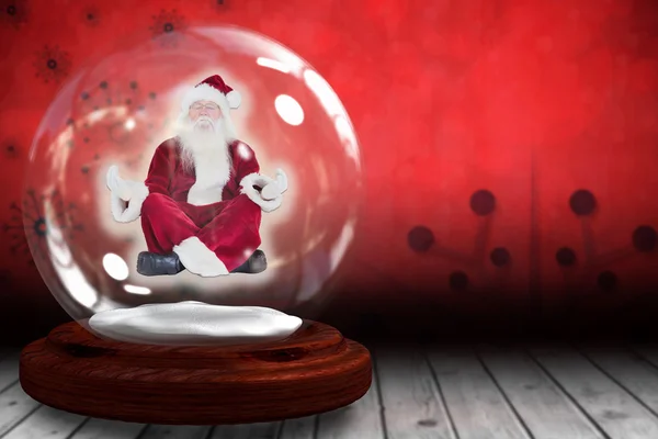 Santa doen yoga in sneeuw globe — Stockfoto