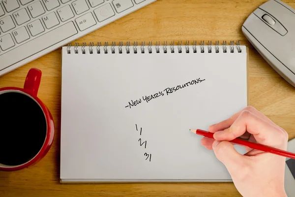 Composite image of hand writing new years resolutions — Stock Photo, Image