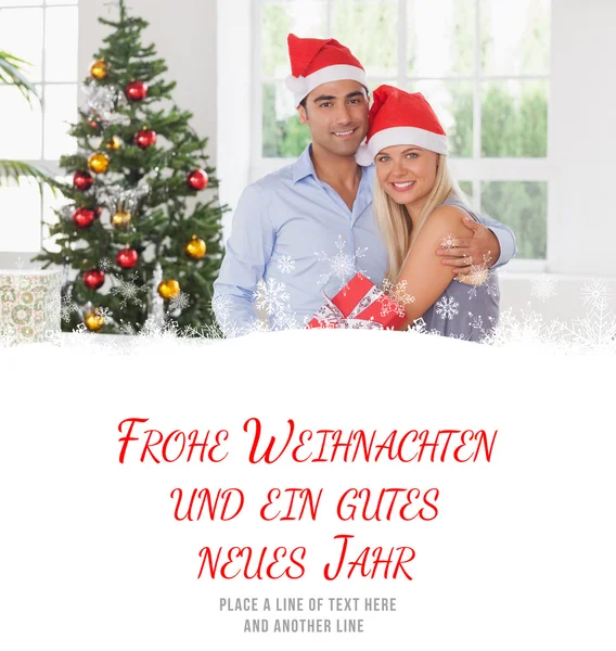 Composite image of happy couple at christmas — Stock Photo, Image