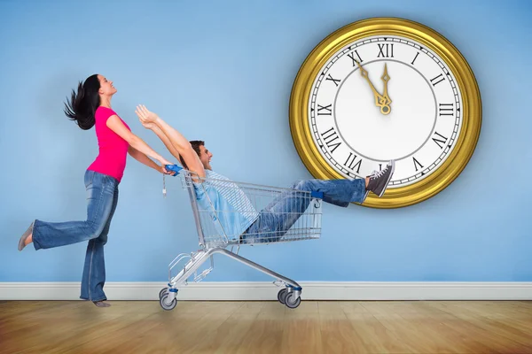 Young couple having fun with shopping cart — Stock Photo, Image