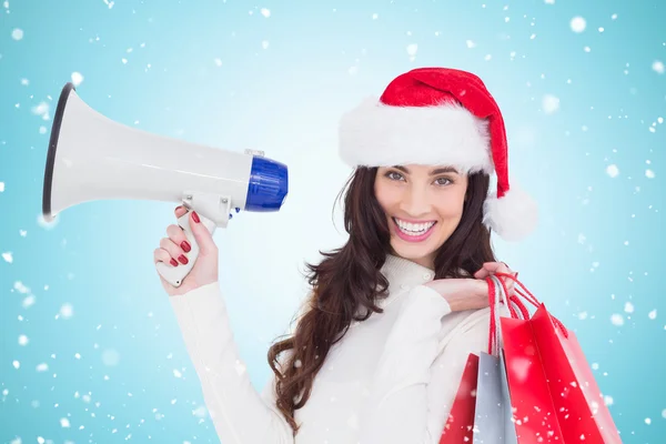 Brunette holding gift bags and megaphone — Stock Photo, Image