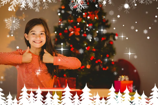 Little girl opening a glowing christmas gift — Stock Photo, Image