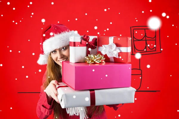 Festive redhead holding pile of gifts — Stock Photo, Image