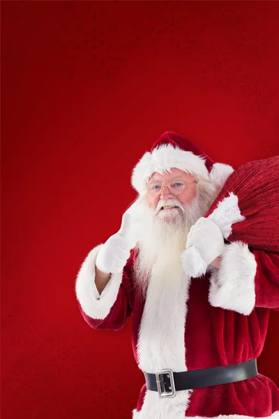 Santa onun çuval taşımak istiyor — Stok fotoğraf
