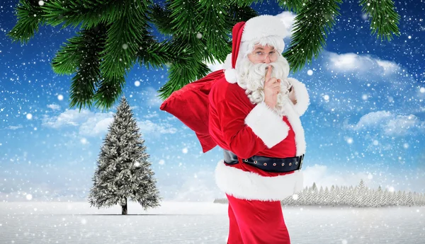 Санта хранит секрет и держит свой мешок — стоковое фото