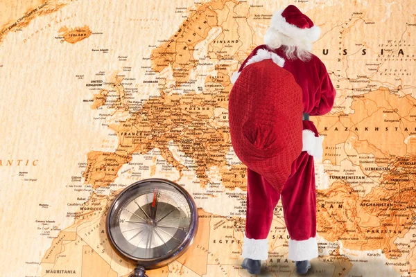 Santa is holding his bag in one hand — Stock Photo, Image