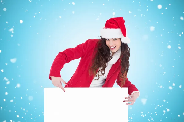Świąteczny brunetka wskazującego plakat biały — Zdjęcie stockowe
