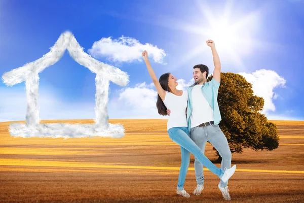 Happy casual couple cheering together — Stock Photo, Image