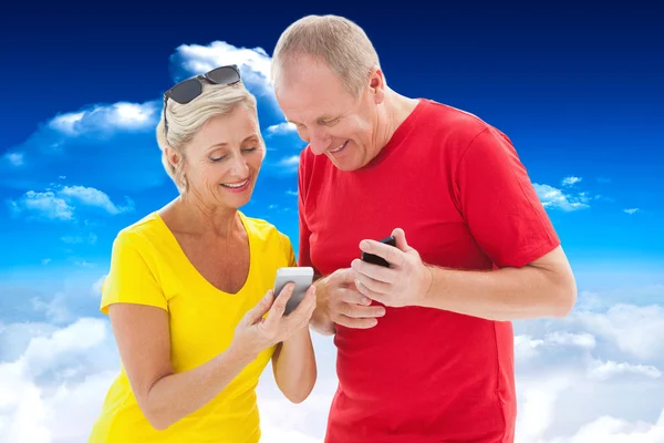 Gärna äldre par titta på smartphone — Stockfoto