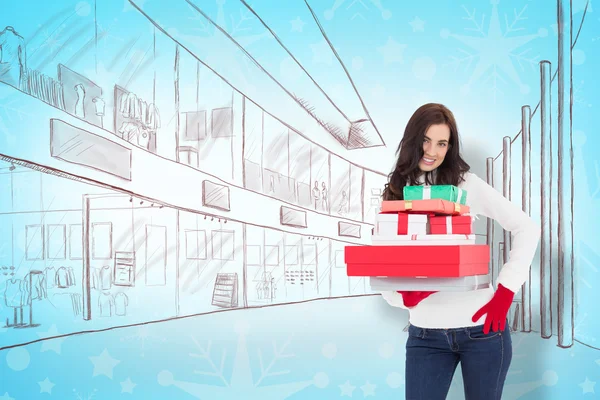 Pretty brunette posing and holding pile of gifts — Stock Photo, Image