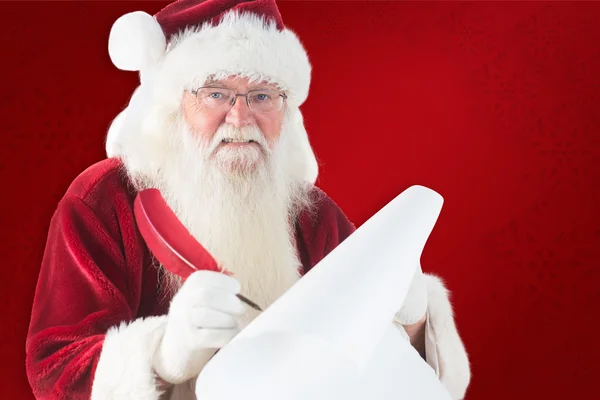 Santa claus schrijven op scroll — Stockfoto