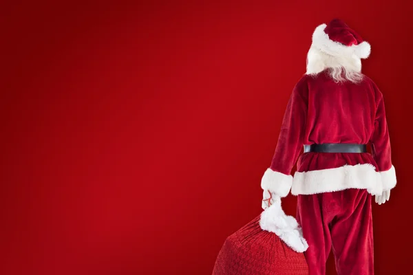 Santa μεταφέρουν σάκο των δώρων — Φωτογραφία Αρχείου