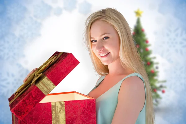 Festive blonde opening gift — Stock Photo, Image
