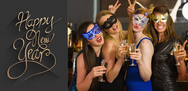 Women wearing masks holding champagne — Stock Photo, Image