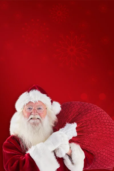 Jolly Santa draagt zijn zak — Stockfoto