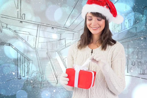 Brunette in santa hat opening gift — Stock Photo, Image