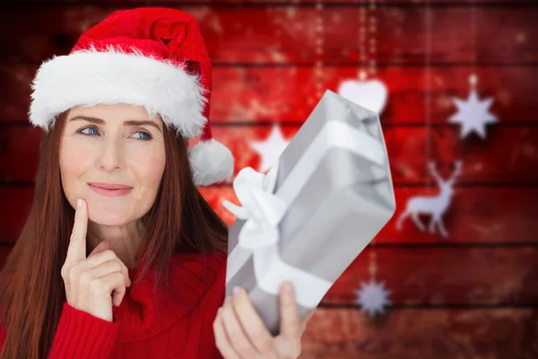 Composite image of redhead holding gift — Stock Photo, Image